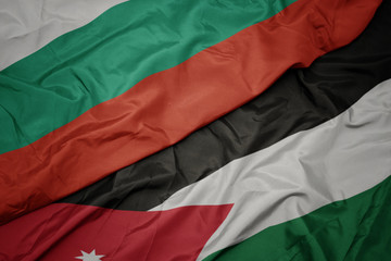 waving colorful flag of jordan and national flag of bulgaria