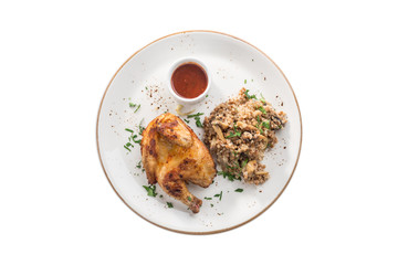 Half chicken tobacco with cooked buckwheat with mushroom and tomato sauce isolated on white background