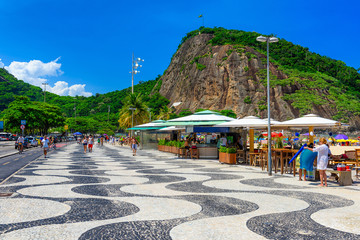 View of Copacabana beach and Leme beach with palms and mosaic of sidewalk in Rio de Janeiro, Brazil