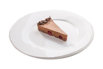 Slice of chocolate mousse cake on white plate isolated on white background