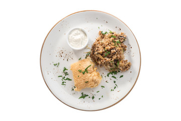 deep fried fish fillet in batter with buckwheat with mushroom and white sauce isolated on white background