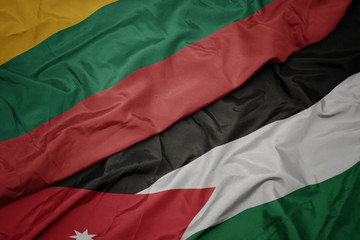 waving colorful flag of jordan and national flag of lithuania.