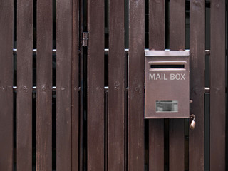 Post box on brow wooden, a mailbox on a wooden fence