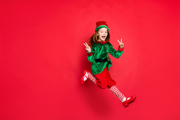 Full length body size view of nice attractive cheerful cheery glad optimistic funny funky overjoyed small little pre-teen elf having fun showing v-sign isolated over bright vivid shine red background - obrazy, fototapety, plakaty