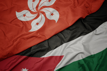 waving colorful flag of jordan and national flag of hong kong.