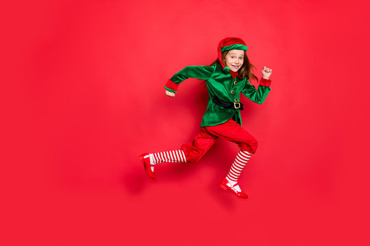 Full length body size view of nice attractive cheerful cheery funny funky carefree small little pre-teen elf having fun running marathon isolated over bright vivid shine red background