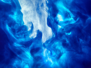Poster color in water. Abstract background., Color paint drops in water. Ink swirling underwater,...