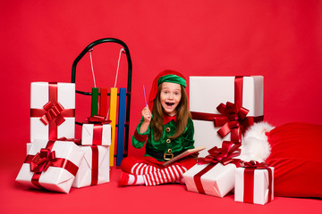 Nice attractive cheerful cheery excited funny funky small little pre-teen elf creating winter holly...