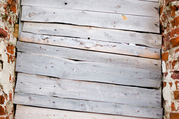 boarded up planks entrance to a half-ruined abandoned old church. boarded up window of an old dilapidated building © Вячеслав Думчев