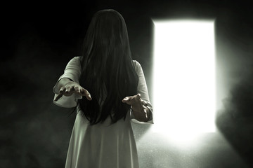 Scary ghost woman on dark background
