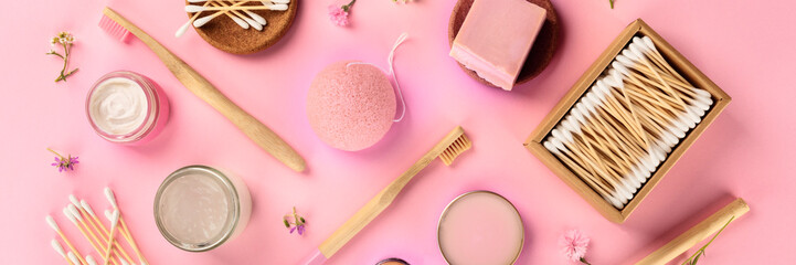Plastic-free, zero waste cosmetics, panoramic flat lay on a pink background. Bamboo toothbrushes, cotton swabs, konjac sponge, natural organic products