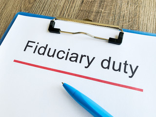 Paper with text fiduciary duty on wood table