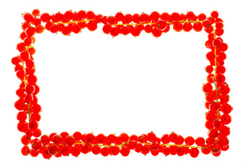 Frame of red currant berries with copy space isolated and  flat layed on a white background.