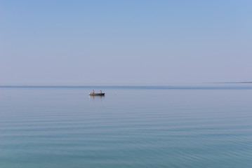 Fototapeta na wymiar Fishermen in a boat on the lake.