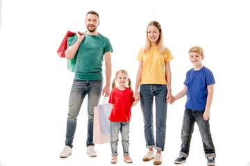 Obraz premium full length view of smiling family with shopping bags isolated on white