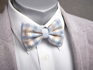 bow tie with a shirt and a jacket on a mannequin