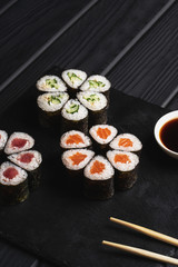 Japanese menu. Sushi roll on a black background.