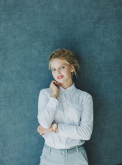 portrait of a business lady in formal wear near the wall