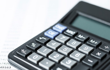 Calculator on white paper with numbers. Business and Finance accounting concept.