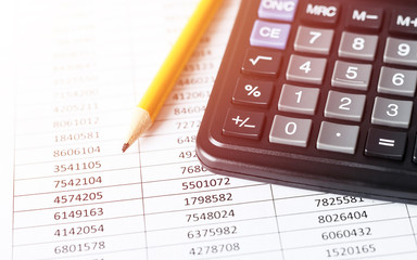 Calculator with pencil on white paper with numbers. Business and Finance accounting concept.