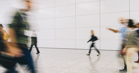 trade fair visitors walking in a clean futuristic corridor