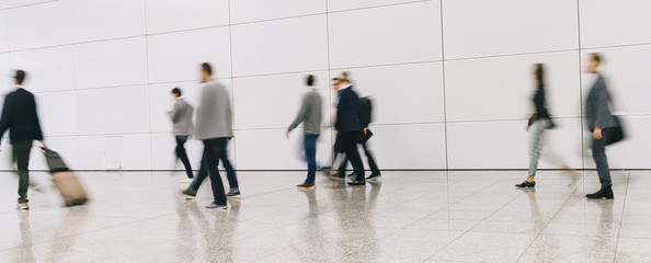 trade fair visitors walking in a clean futuristic corridor