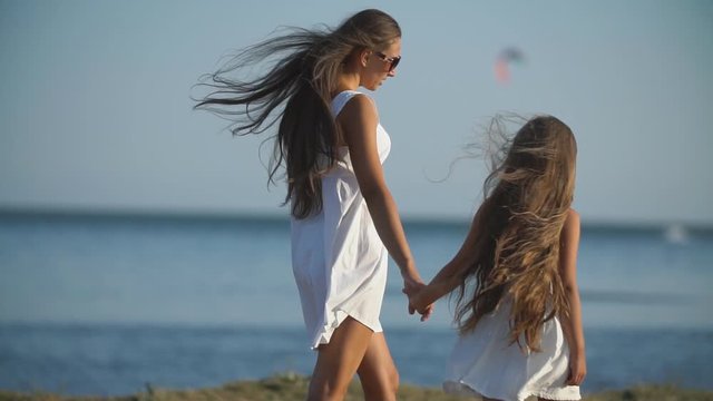 mother with daughter in white dresses