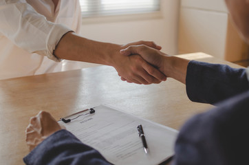 Partnership. two business people shaking hand after business signing contract in meeting room at company office, job interview, investor, success, negotiation, partnership, teamwork, financial concept