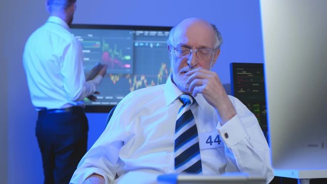 Aged stock market broker in office