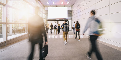 blurred business people at a trade fair with banner for copy space