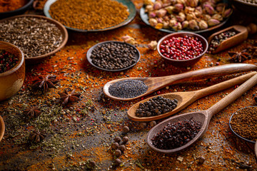 Colorful spices in wooden spoons