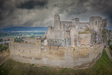 Fototapeta na wymiar Aerial view of medieval Beckov castle with inner and outer courtyard, cannon tower, castle gate, chapel in Slovakia 
