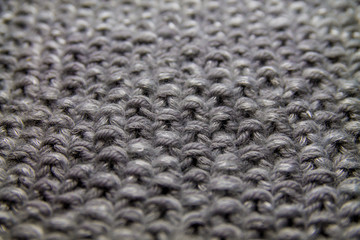 gray horizontal knitted pattern background with bokeh