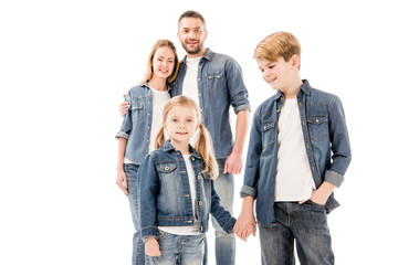 Fototapeta premium happy smiling family in jeans embracing and holding hands isolated on white
