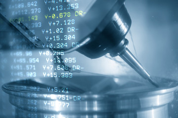 The abstract scene of 5-axis CNC milling machine and  G-code data cutting the magnesium wheel parts by solid ball endmill tools. The automotive parts manufacturing process by 5-axis machining center.