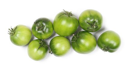 Green unripe tomatoes isolated on white background, top view