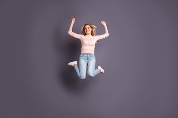 Fototapeta premium Full size photo of pretty lady jumping high competitive mood cheerleading wear casual stylish outfit isolated grey color background
