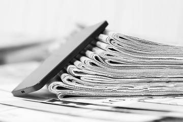 Newspapers amd Smartphone. News Pages with Headlines and Articles and Mobile Phone. Different Sources of Information - Internet or Papers. Concept for Communication 