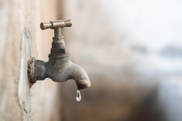 Old tap with drop of water.