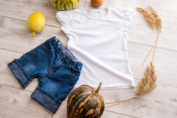 T-Shirt and jeans Mockup on a White Wooden Background