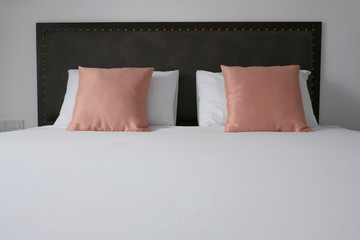 Elegant leather bed with pillows decorated in hotel room