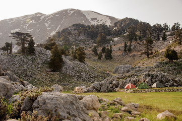 Landscape of tourist tents on the rocky hills at the foot of the mountain Tahtali