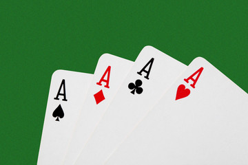 close up on a poker of aces isolated on green table with  copy space for your text