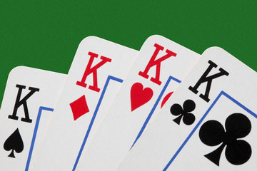 close up on a poker of kings isolated on green table with  copy space for your text