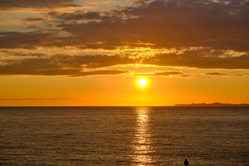 Sunset over Adriatic Sea with golden dramatic sky panorama.