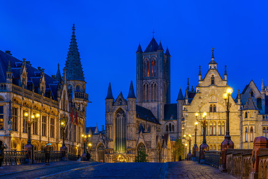 Medieval city of Gent (Ghent) in Flanders with Saint Nicholas Church and Gent Town Hall, Belgium. Nigth cityscape of Gent.