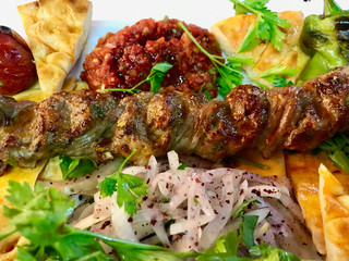 Turkish Adana / Urfa Kebab Topkapi and Pide Lavash served with Kebap Plate at Restaurant.