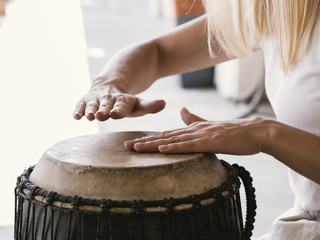 Young person playing latin drum