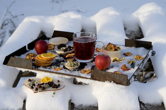 New Year or Christmas flat lay top view with Hot red tea  with different herb, fresh and dry fruit and berry