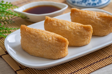 Rice ball wrapped in deep fried tofu pouches (Inari Sushi), Japanese food